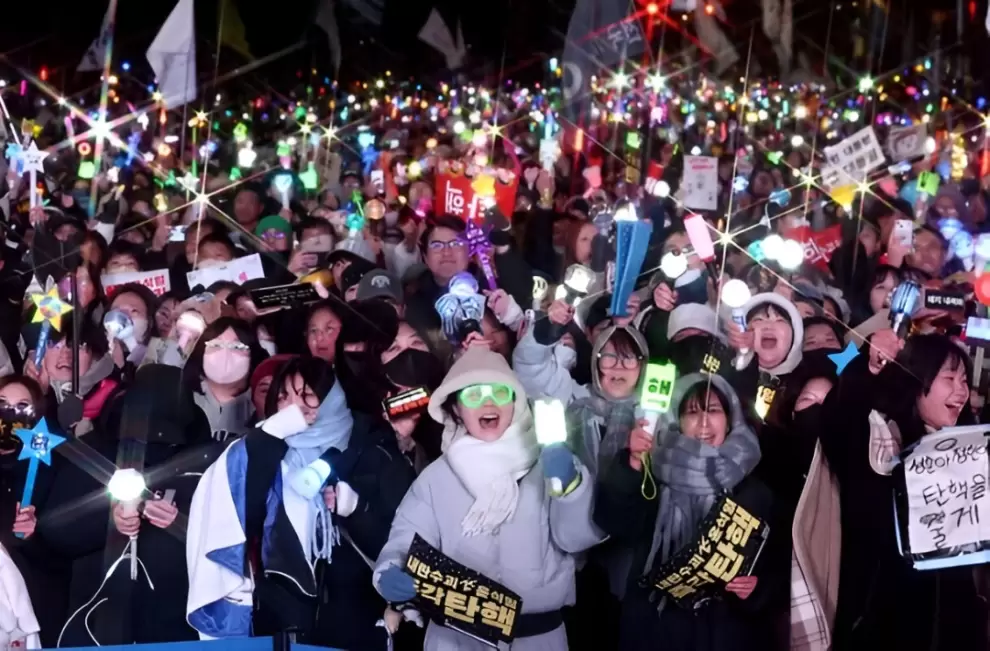 Jovenes coreanos con sus lightsticks con los que apoyan a su banda favorita del kpop salen a manifestar por el juicio pol�tico del presidente Yoon.