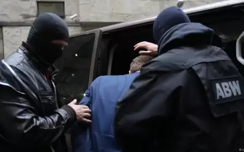 Agentes de la Agencia de Seguridad Interna (ABW) escoltan a otro civil sospechoso de espionaje, tras una audiencia en el Tribunal de Varsovia.