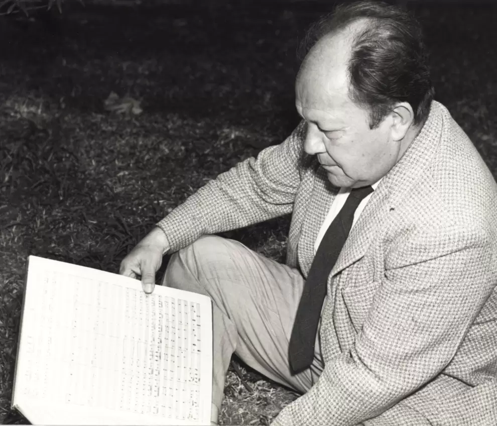 Jos� A. Flores con una partitura sentado en el pasto (Buenos Aires, 1959). Cortes�a