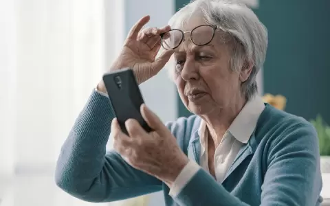 Adulto mayor con celular inteligente.